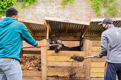 Volunteers work the compost bin at Brewerytown Garden
